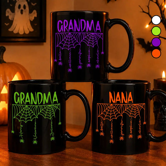 Three personalized Halloween mugs reading Grandma and Nana with spider webs and names